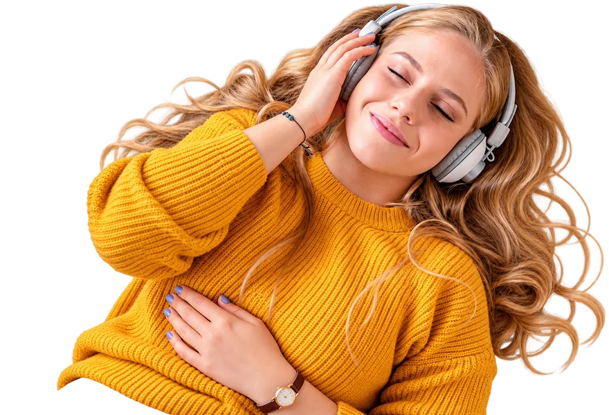 A woman in a mustard sweater listening on white headphones with her eyes closed.