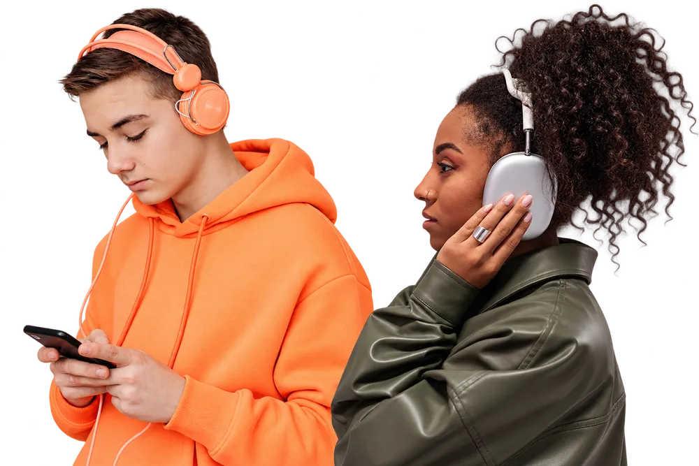 Two listeners wearing headphones, back to back and unaware of each other &mdash; one scrolling on a phone, the other with a hand resting on an earcup &mdash; each hearing music on their own.